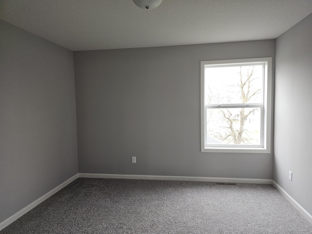 17121 61st St NE, Otsego, MN 55330 - empty room with baseboards, visible vents, and dark carpet