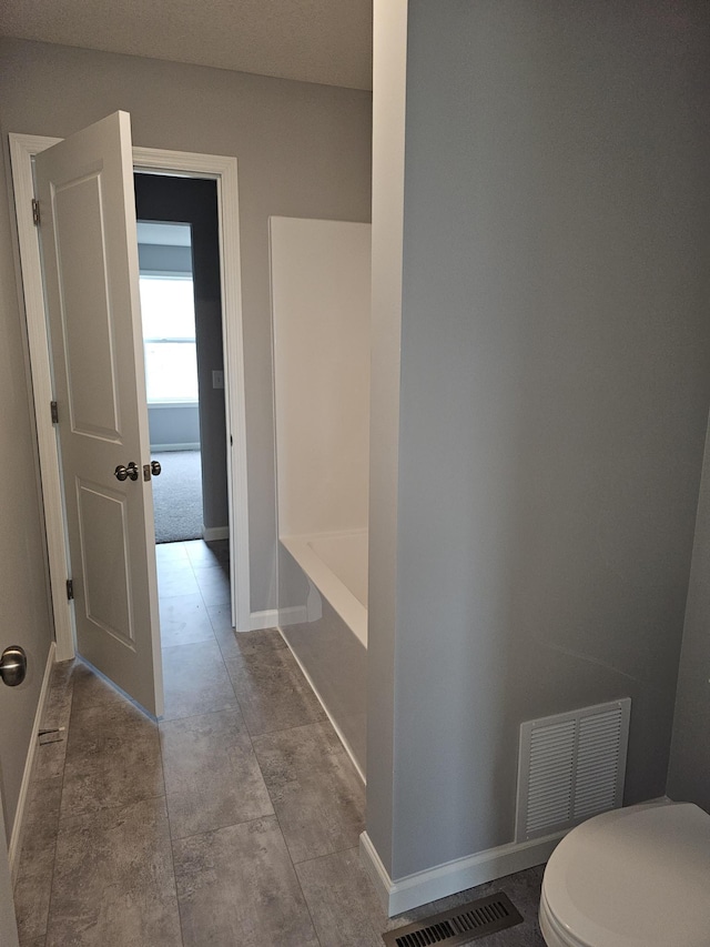 17121 61st St NE, Otsego, MN 55330 - bathroom featuring a washtub, baseboards, and visible vents
