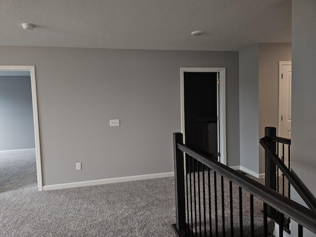 17121 61st St NE, Otsego, MN 55330 - hallway featuring carpet flooring, a textured ceiling, and an upstairs landing