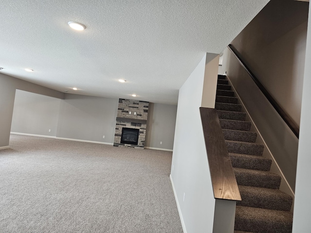 17121 61st St NE, Otsego, MN 55330 - staircase with a textured ceiling, a fireplace, baseboards, carpet flooring, and recessed lighting