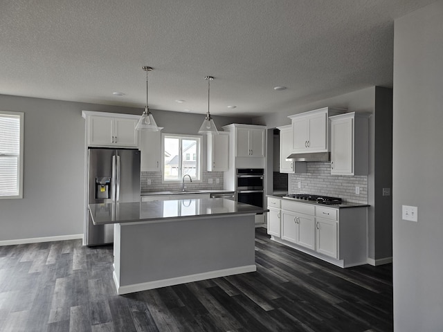 17121 61st St NE, Otsego, MN 55330 - kitchen with appliances with stainless steel finishes, under cabinet range hood, dark wood-style floors, and white cabinetry