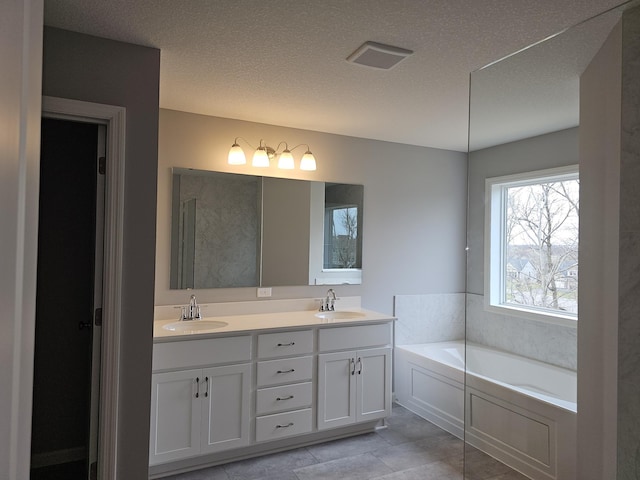 17121 61st St NE, Otsego, MN 55330 - full bath featuring double vanity, a garden tub, a textured ceiling, and tile patterned flooring