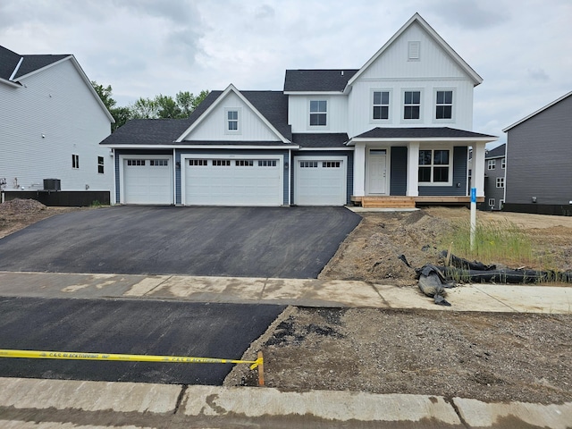 17121 61st St NE, Otsego, MN 55330 - view of front facade featuring asphalt driveway, a porch, an attached garage, and roof with shingles