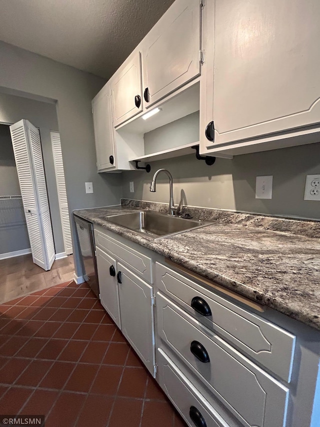 4371 Wilshire Blvd Unit 202, Mound, MN 55364 - kitchen with white cabinetry, stainless steel dishwasher, and dark countertops
