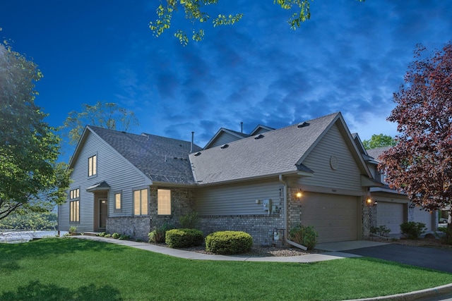 3662 Pond View Pt, Eagan, MN 55122 - view of property exterior with asphalt driveway, a yard, a shingled roof, and a garage