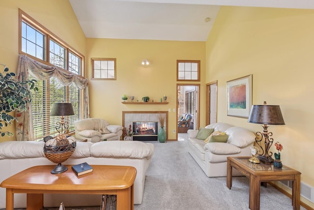 3662 Pond View Pt, Eagan, MN 55122 - carpeted living area featuring a tiled fireplace, high vaulted ceiling, and baseboards