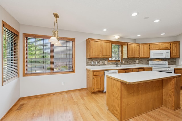 3662 Pond View Pt, Eagan, MN 55122 - kitchen featuring white appliances, a sink, light countertops, tasteful backsplash, and recessed lighting