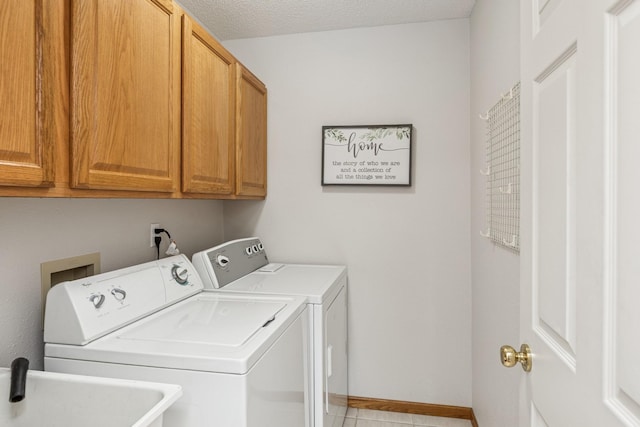 3662 Pond View Pt, Eagan, MN 55122 - laundry room featuring independent washer and dryer, cabinet space, and light tile patterned floors