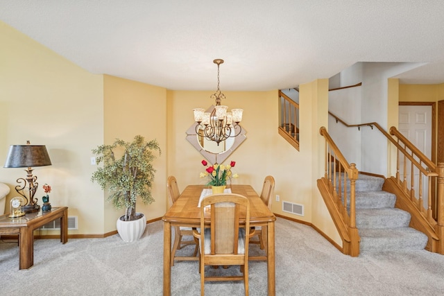 3662 Pond View Pt, Eagan, MN 55122 - dining area featuring light carpet, stairway, a chandelier, and baseboards