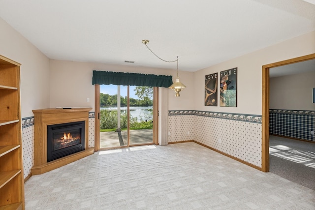 3662 Pond View Pt, Eagan, MN 55122 - unfurnished living room with carpet floors, a wainscoted wall, a glass covered fireplace, and a water view
