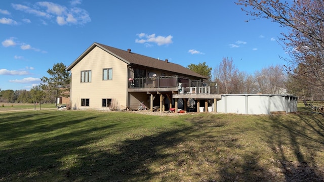 back of house with a wooden deck and a yard