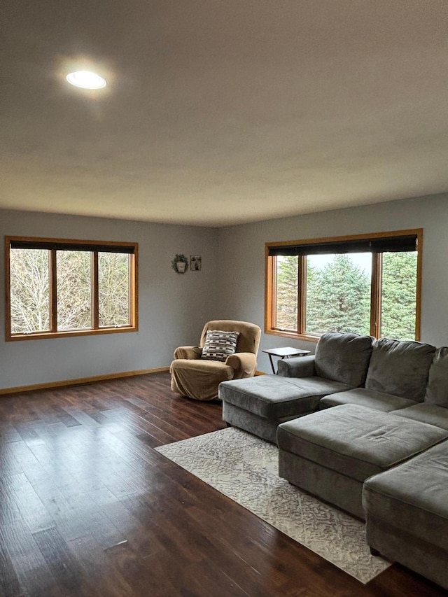 living area with baseboards, recessed lighting, and wood finished floors