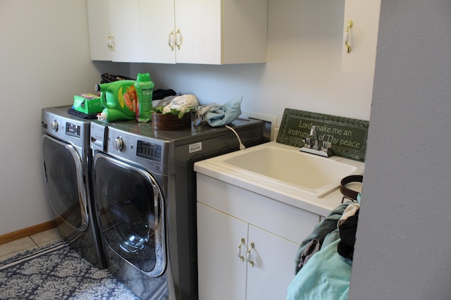 laundry room with cabinet space, a sink, washer and clothes dryer, and tile patterned flooring