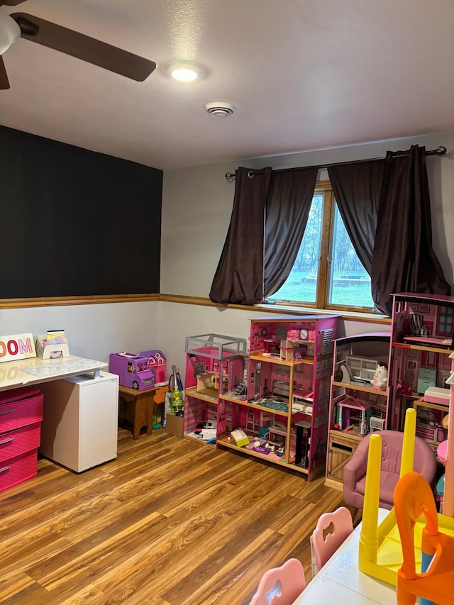 playroom with ceiling fan and wood finished floors