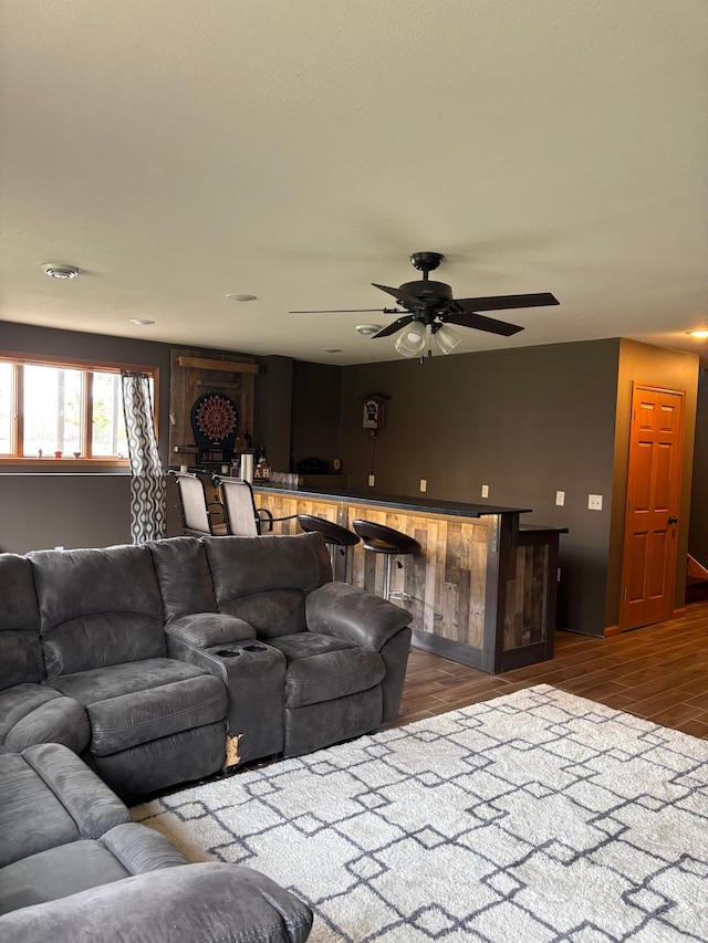 living room with a ceiling fan and wood finished floors