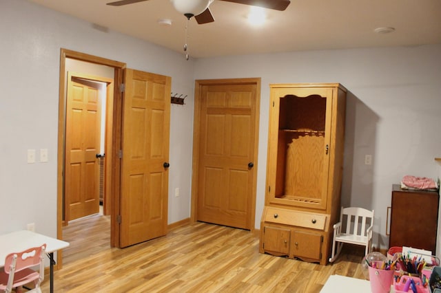 bedroom with ceiling fan and light wood-style flooring