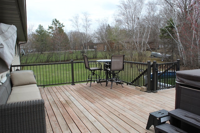 wooden terrace featuring a yard