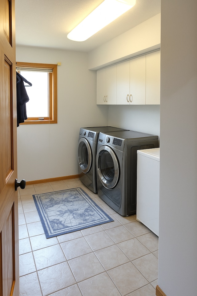 602 Nelson St W, Eagle Bend, MN 56446 - laundry area with washing machine and clothes dryer, cabinet space, and light tile patterned flooring