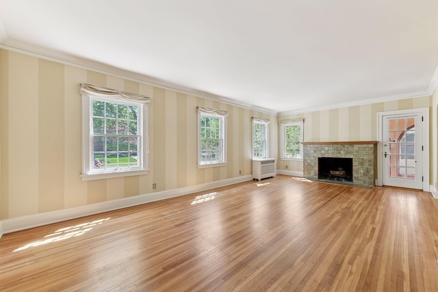 4606 Drexel Ave, Edina, MN 55424 - unfurnished living room with ornamental molding, light wood-style floors, baseboards, wallpapered walls, and a tile fireplace