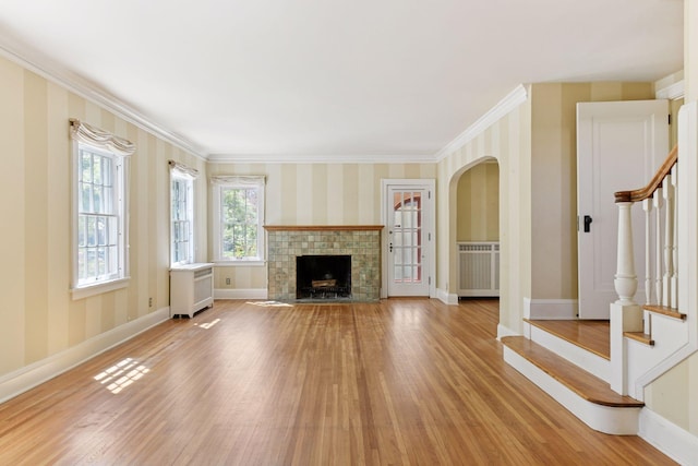4606 Drexel Ave, Edina, MN 55424 - unfurnished living room featuring stairs, light wood finished floors, baseboards, wallpapered walls, and crown molding