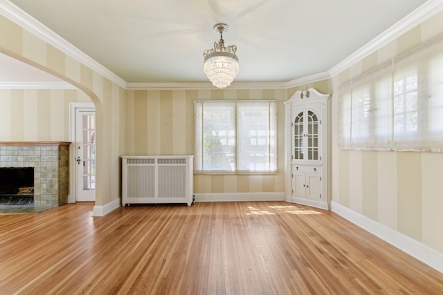 4606 Drexel Ave, Edina, MN 55424 - unfurnished living room with radiator heating unit, wood finished floors, a chandelier, baseboards, and wallpapered walls