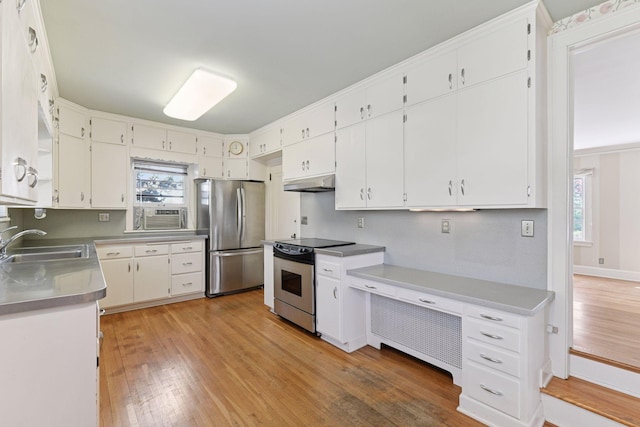 4606 Drexel Ave, Edina, MN 55424 - kitchen featuring stainless steel appliances, a sink, under cabinet range hood, light wood-style floors, and white cabinets