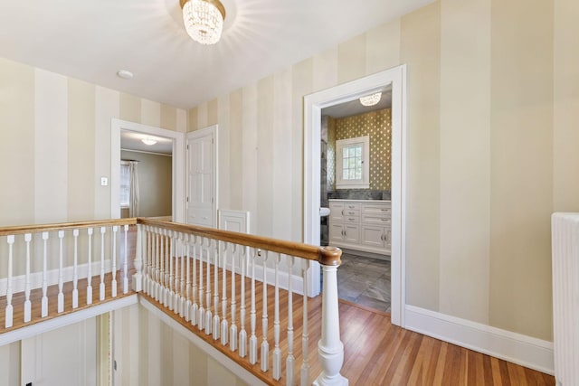 4606 Drexel Ave, Edina, MN 55424 - corridor featuring wallpapered walls, baseboards, light wood-type flooring, an upstairs landing, and radiator heating unit