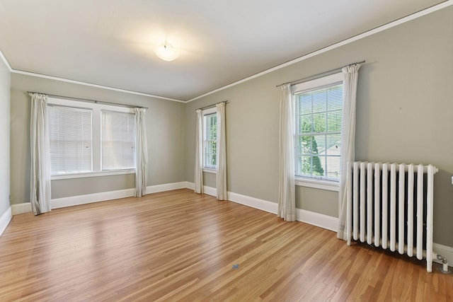 4606 Drexel Ave, Edina, MN 55424 - unfurnished room with radiator heating unit, light wood-style flooring, crown molding, and baseboards