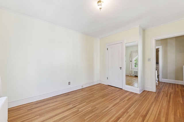 4606 Drexel Ave, Edina, MN 55424 - unfurnished bedroom featuring light wood-type flooring, crown molding, radiator, and baseboards