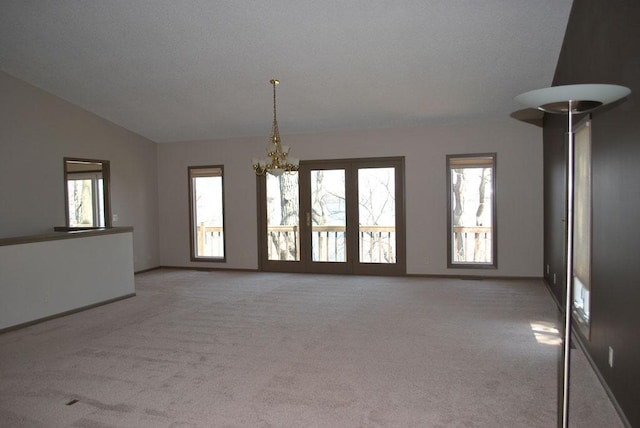 767 Shoreacres Dr, Fairmont, MN 56031 - unfurnished room with lofted ceiling, a notable chandelier, light colored carpet, and baseboards