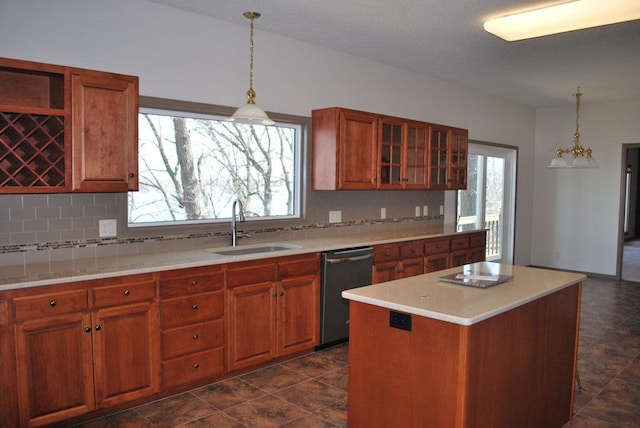 767 Shoreacres Dr, Fairmont, MN 56031 - kitchen with brown cabinets, dishwashing machine, decorative backsplash, and a sink