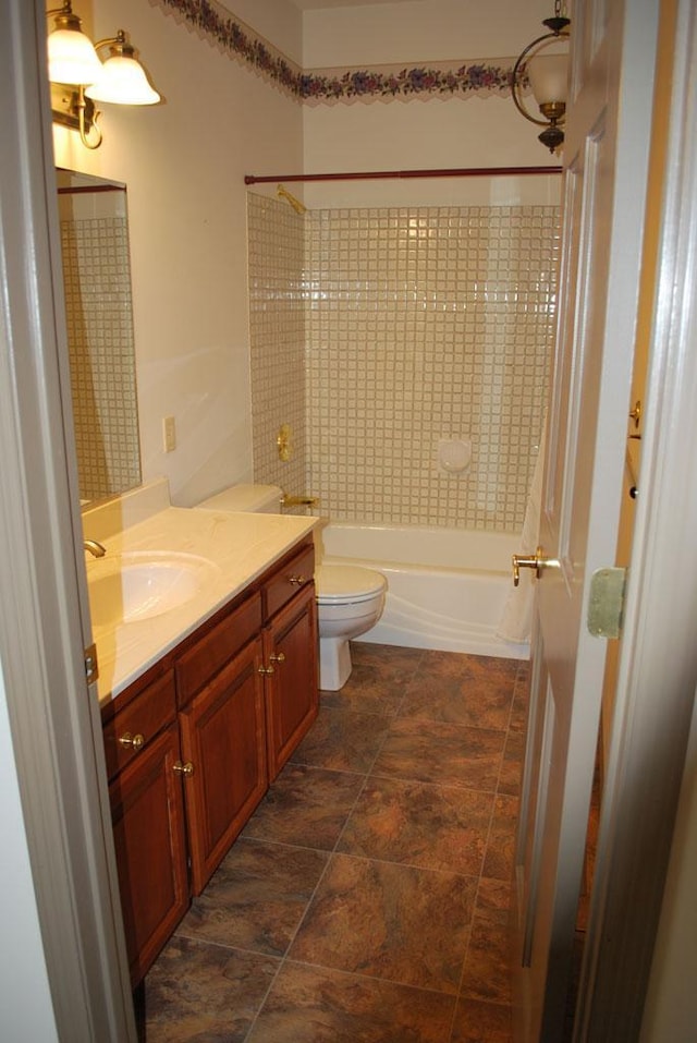 767 Shoreacres Dr, Fairmont, MN 56031 - full bathroom featuring shower / bathing tub combination, toilet, stone finish floor, and vanity