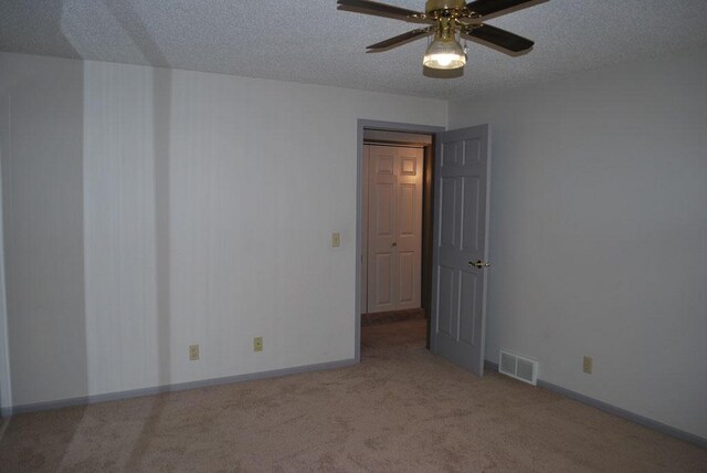 767 Shoreacres Dr, Fairmont, MN 56031 - carpeted spare room featuring baseboards, visible vents, a ceiling fan, and a textured ceiling