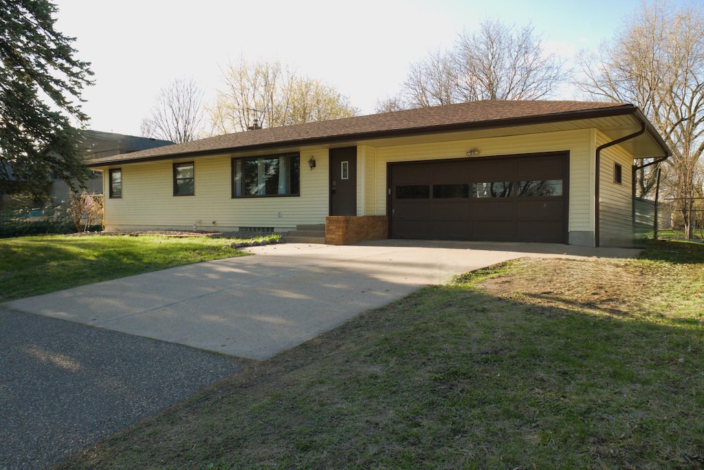 ranch-style home featuring a garage, a front yard, concrete driveway, and crawl space