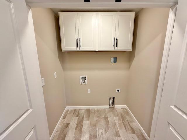 washroom with electric dryer hookup, baseboards, washer hookup, and light wood-style floors