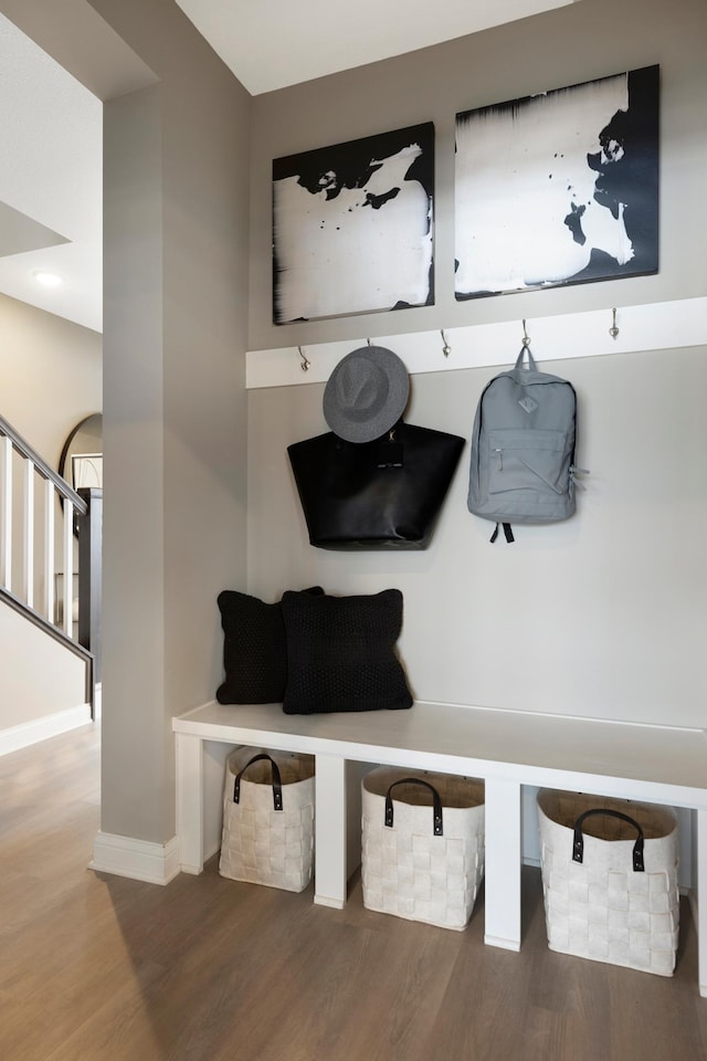 mudroom with baseboards and wood finished floors