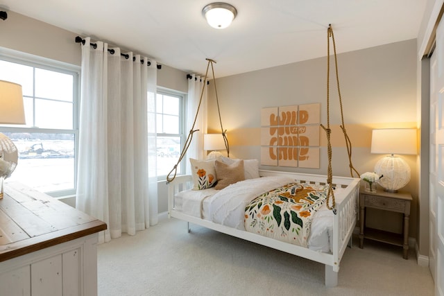 carpeted bedroom with baseboards