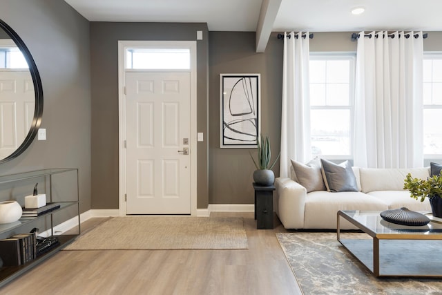 entryway featuring wood finished floors and baseboards