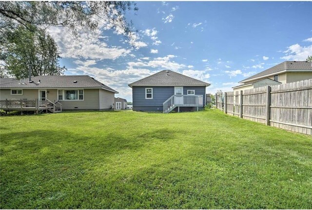 516 Park Island Rd Unit 1, Center City, MN 55012 - back of property with fence, a deck, and a lawn