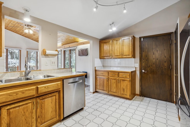 kitchen with stainless steel dishwasher, lofted ceiling, light floors, plenty of natural light, and a sink
