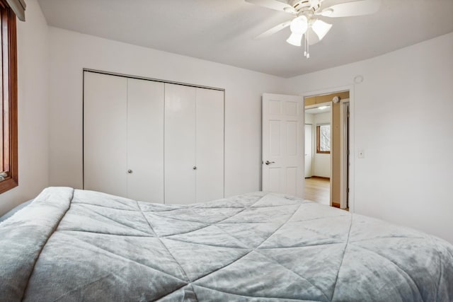 bedroom featuring ceiling fan and a closet