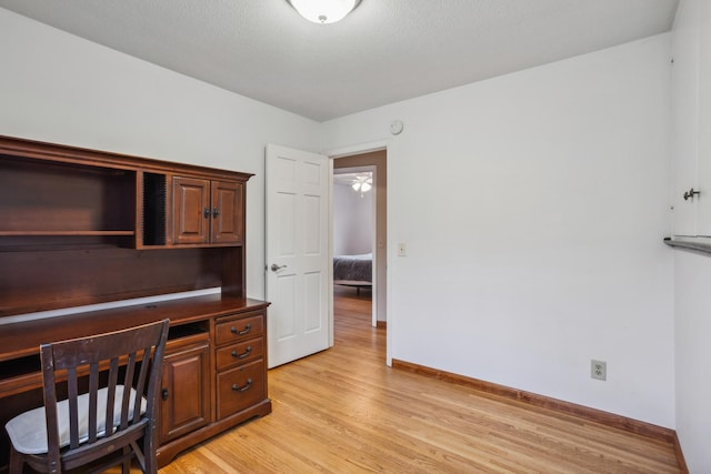 office area featuring baseboards and light wood-style floors