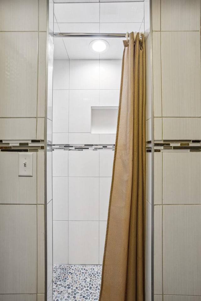 bathroom with tiled shower