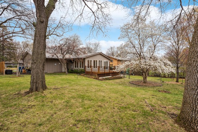 view of yard featuring fence and a wooden deck