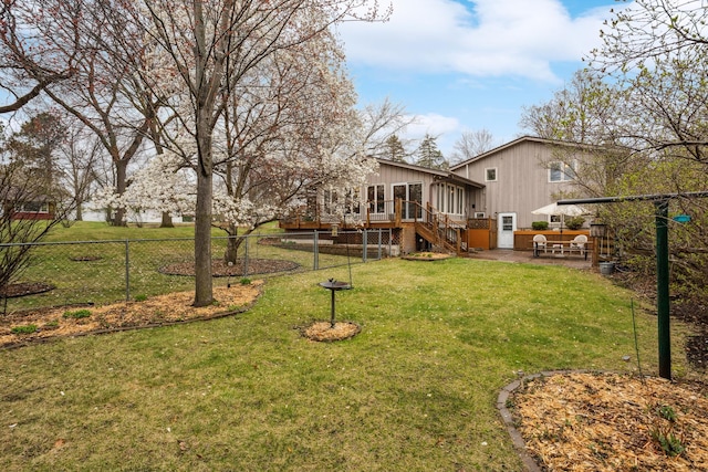 view of yard with a wooden deck, a patio area, a sunroom, stairway, and fence