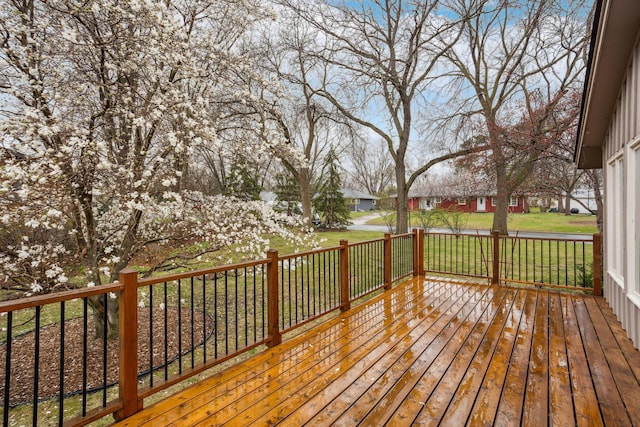 wooden deck with a lawn and a residential view