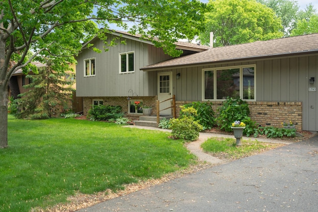 3293 Rice Creek Ter, New Brighton, MN 55112 - tri-level home with a front lawn, brick siding, and roof with shingles