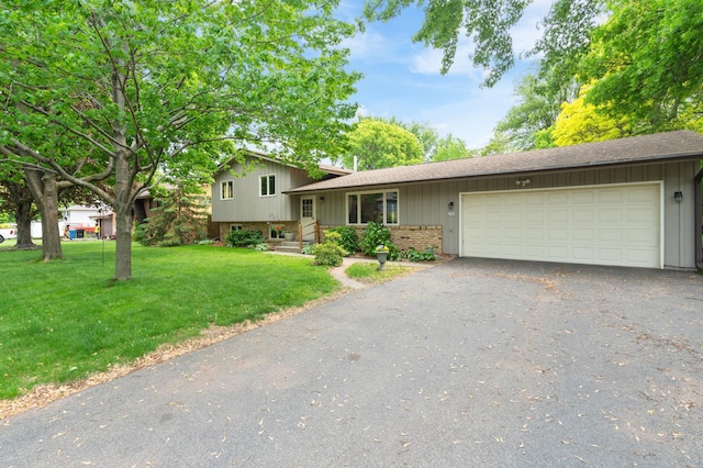 3293 Rice Creek Ter, New Brighton, MN 55112 - split level home featuring asphalt driveway, an attached garage, a shingled roof, a front yard, and board and batten siding