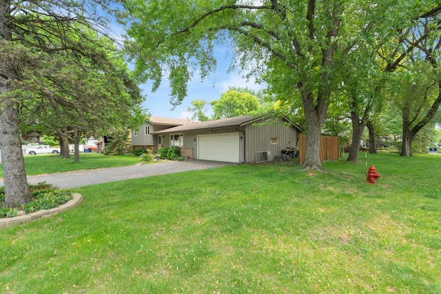 3293 Rice Creek Ter, New Brighton, MN 55112 - view of front facade featuring asphalt driveway, a garage, a front lawn, and board and batten siding