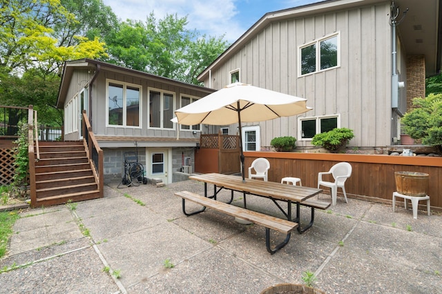 3293 Rice Creek Ter, New Brighton, MN 55112 - view of patio / terrace featuring stairs, outdoor dining area, and a wooden deck